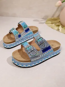 Detailed view of blue platform sandals with rhinestones, crystals and cork soles