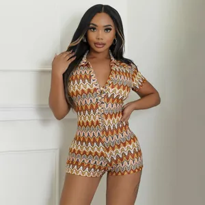 Close-up of women's short-sleeved romper featuring a colorful zigzag geometric pattern