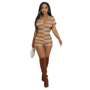 Detailed view of women's wave pattern V-neck short sleeve romper in warm tones.