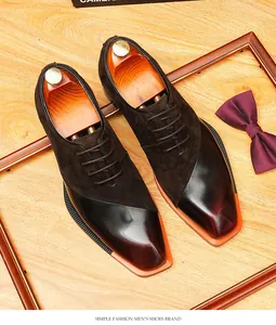 Detailed view of men's vintage brown suede and polished leather patchwork Oxford shoes.