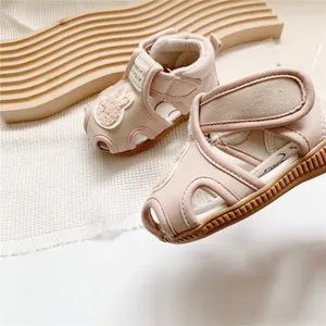 Close-up of pink morino baby sandals with cartoon rabbit patch and non-slip rubber sole