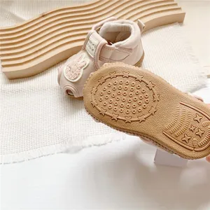 Detailed view of non-slip rubber sole with star patterns on pink baby sandals