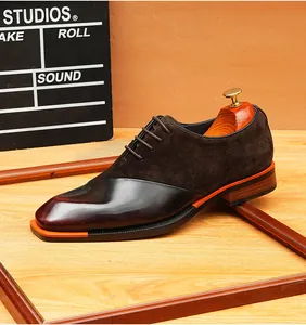 Elegant detail of retro dark brown suede and polished leather lace-up Oxford shoes.