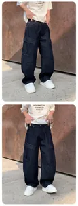 Loose straight deep blue washed denim cargo pants with side pockets in outdoor setting