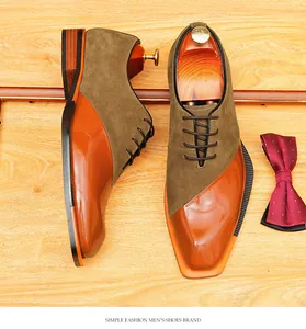 Close-up of vintage brown suede and orange patent leather Oxford shoes with bow tie detail