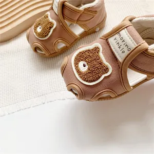 Close-up of toddler sandals with cute bear patch and morino rinkle brand tag