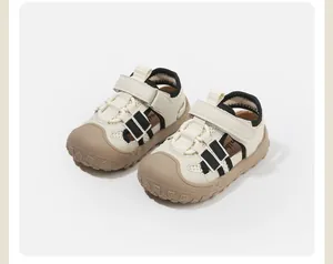 Close-up of beige toddler closed-toe sandals with breathable mesh and velcro straps.