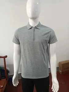 Detailed view of a grey short-sleeved knit polo shirt with a stylish half-zipper neckline