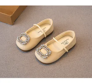 Nahaufnahme der luxuriösen Strass-Schnalle an beigen Mädchen-Prinzessinnenschuhen.