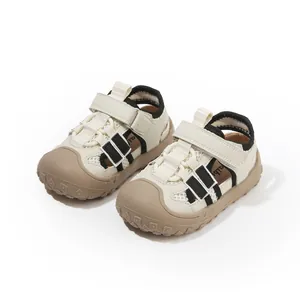 Beige toddler walking sandals with black stripes and protective brown toe caps for kids