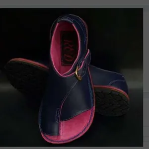 Close-up view of navy blue and pink women's toe-loop flat sandals with side buckle