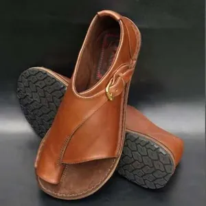 Detailed view of brown vintage leather buckle toe-loop flat sandals for women.