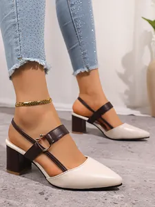 Close-up detail of cream and brown pointed toe chunky heel sandals with metal buckle