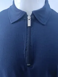 Detailed macro view of navy blue men's polo shirt featuring a sleek silver metal half-zipper