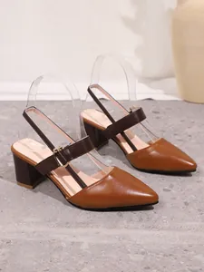 Close-up detail of women's brown pointed-toe block heel sandals with an adjustable buckle strap