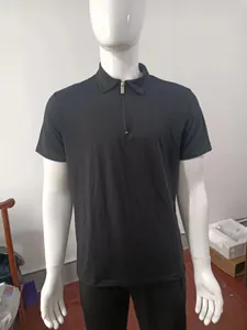 Detailed view of a solid black men's short sleeve polo shirt with a functional half-zipper collar