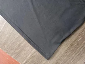 Macro view of the high-quality hem stitching on a charcoal grey knit polo shirt