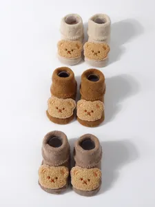 Three pairs of cozy baby socks with cute 3D plush bear faces in warm earthy tones