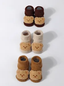 Detailed view of thickened baby terry floor socks with cute 3D cartoon bear patches.