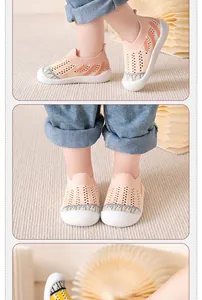Detail of breathable pink mesh walking shoes for children on a soft beige carpet