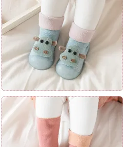 Close-up detail of knitted baby walking shoes with cute animal decoration and soft sole