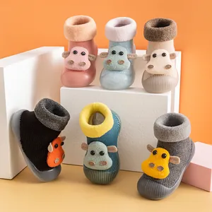 Anti-slip winter baby floor sock shoes with cute cartoon cow design in various colors.