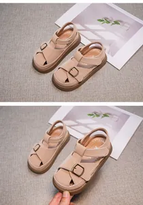 Close-up of beige girls' closed-toe sandals with soft soles and buckle straps.
