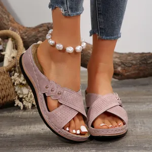 Mauve platform sandals with perforated criss-cross straps, peep-toe, and stud details.