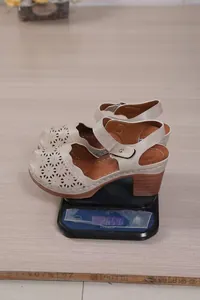 Vintage beige hollow-out chunky heel sandals for women, weight shown on a black scale