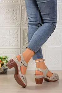 Detailed view of retro cutout beige sandals featuring a chunky wood-grain heel and strap