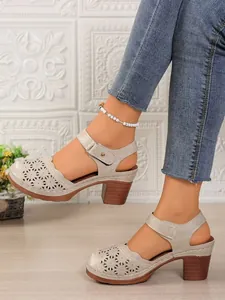 Vintage hollow-out closed-toe sandals for women with chunky heels shown on model's feet