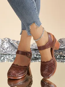 Retro brown laser-cut closed toe sandals for women featuring chunky high heels