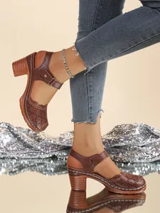 Detail view of vintage brown hollow-out closed-toe sandals with chunky high heels