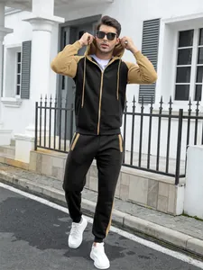 Full-body view of men's black and khaki color-blocked hooded tracksuit for autumn winter