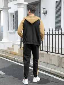 Back view of stylish men's color-block tracksuit with raglan sleeves and mustard yellow hoodie