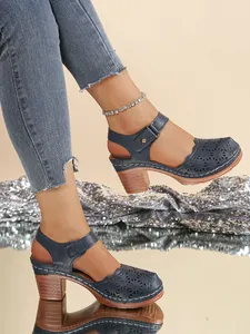 Retro navy blue hollow-out sandals with chunky wooden heels and ankle strap for women