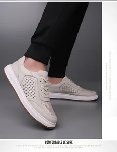Detailopname van ademende, geperforeerde herensneakers van echt leer in wit.