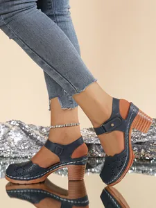 Elegant blue retro hollow-out closed-toe sandals with comfortable chunky heels on model