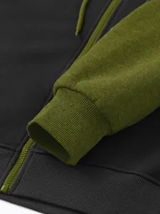 Close-up detail showing the olive green ribbed cuff and zipper on a dark grey hoodie