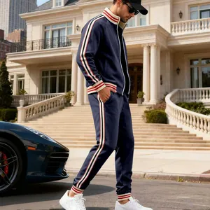 Close-up detail of men's navy leisure tracksuit featuring red and white striped web trim