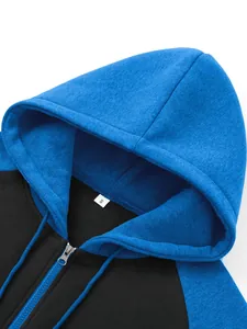 Close-up detail of a blue and black color-block raglan sleeve hoodie with hood and zipper