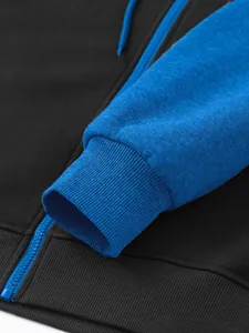 Detailed view of ribbed cuff and blue zipper on a men's black fleece hoodie