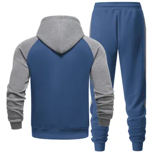 Men's raglan sleeve tracksuit set with blue and grey color-block hoodie and pants.