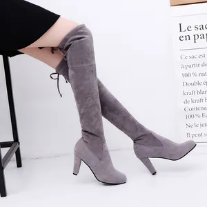 Detailed side view of elegant grey suede over-the-knee high heel boots for women