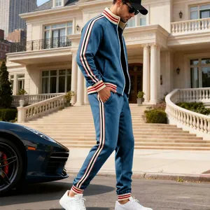 Full view of men's blue tracksuit set featuring athletic side stripes on a model