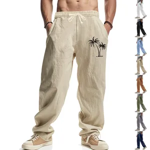 Detailed view of the palm tree print on these men's breathable linen wide-leg beach trousers