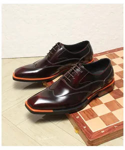 Detailed side view of burgundy men's wingtip Oxford shoes with orange sole accents