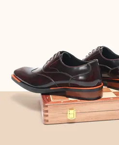 Detailed side view of classic glossy burgundy leather Oxford shoes for professional men