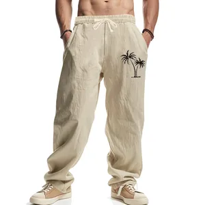 Detail view of men's loose linen trousers featuring palm tree print for beach wear