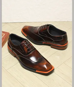 Elegant brown patent leather oxford shoes for men with unique orange sole detail